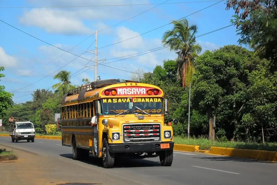 A yellow bus signed Masaya Granada on the highway