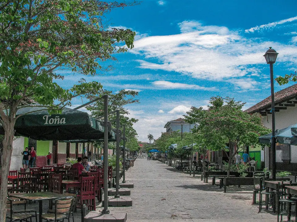 Calle La Calzada in Granada, lined with restaurant tables